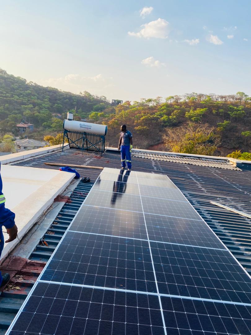 Dosmac two-man team commissioning a rooftop solar installation in Harare, Zimbabwe