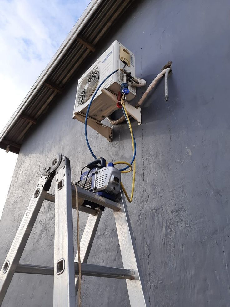 Split-type air conditioning unit being installed in modern residential living room, Harare