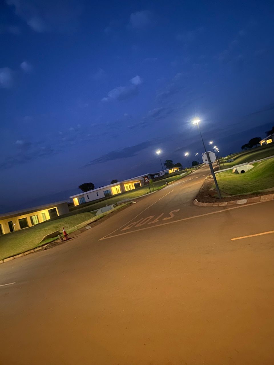 Completed housing estate street lighting glowing at dusk — Zimbabwe residential development