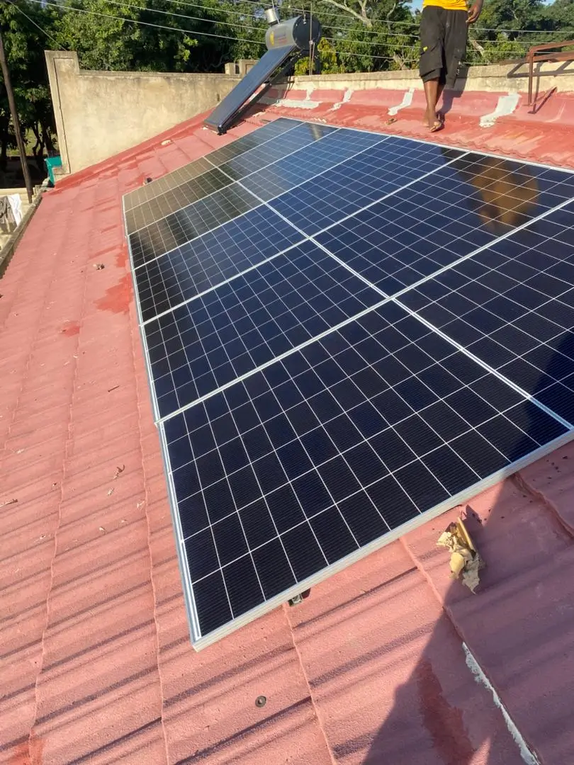 8-panel monocrystalline solar array on red tiled residential roof, Harare